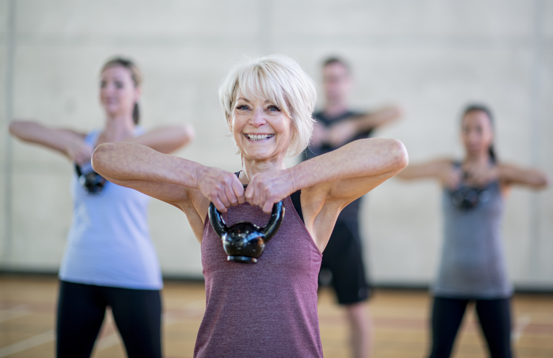 Senior Woman In Fitness Class Using A Kettlebell Stock Photo