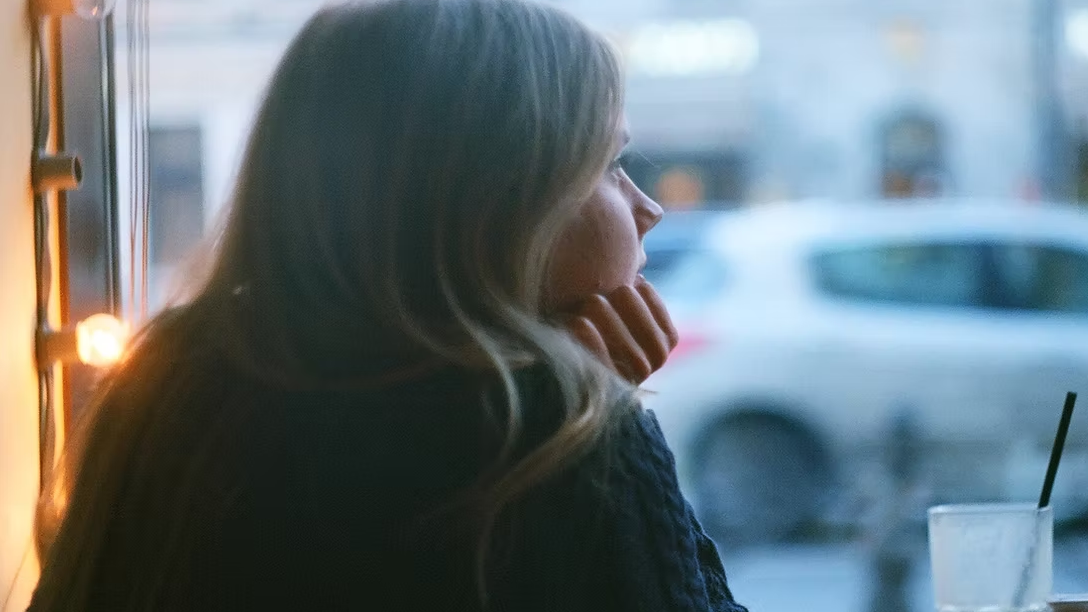 Young Woman Looking Out Of Window Aspect Ratio 1600 900